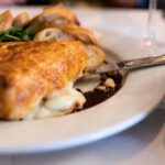 Baked Brie with hazelnuts, cinnamon puff pastry, arugula, port syrup