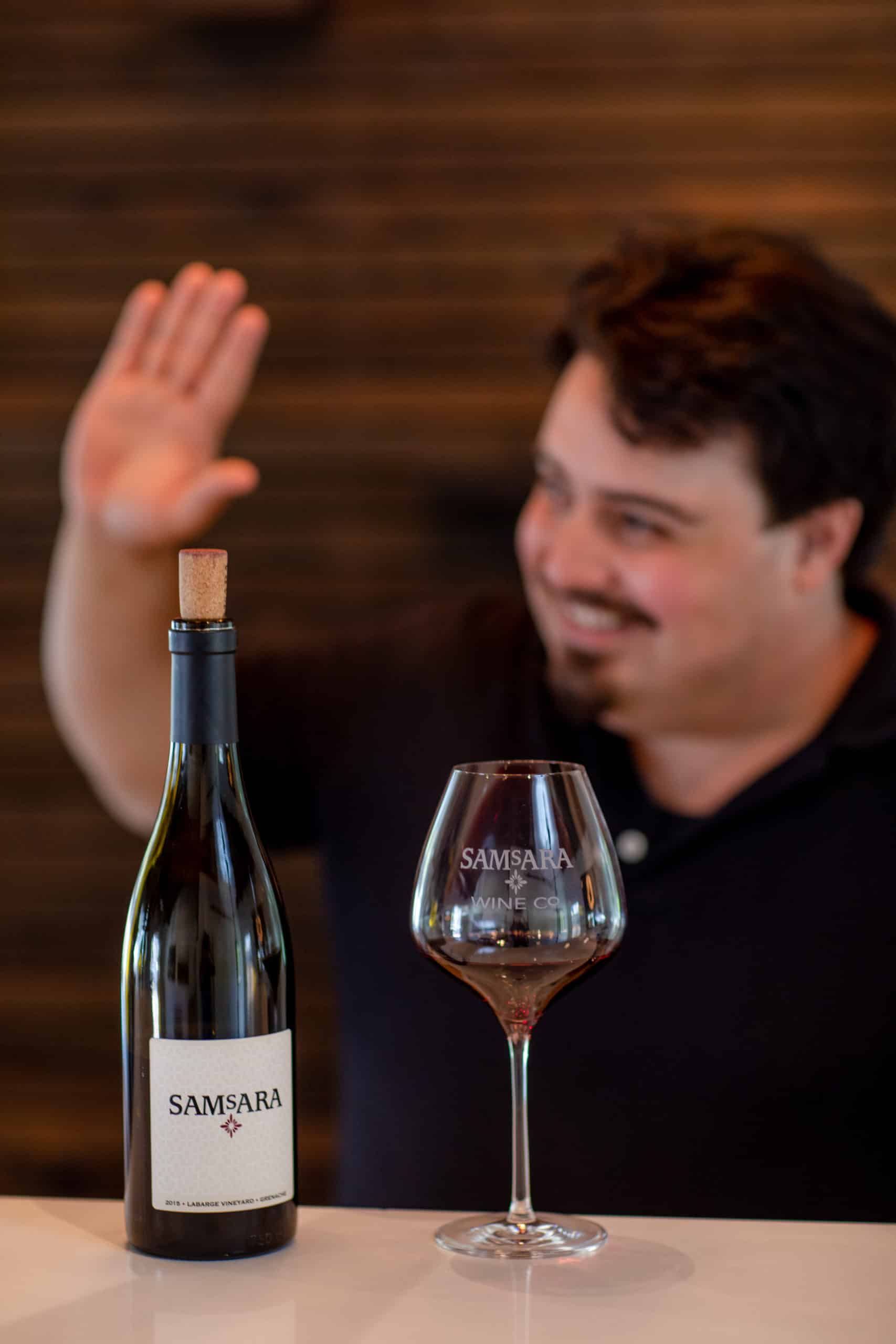 Devon serving wine at SAMsARA Wine's tasting room in Los Olivos, CA