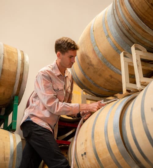 Neal Kennedy, SAMsARA Cellar Master, tops off barrels at the SAMsARA winery.